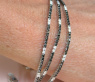 Dreireihiges Tennisarmband mit schwarzen und weißen Diamanten
